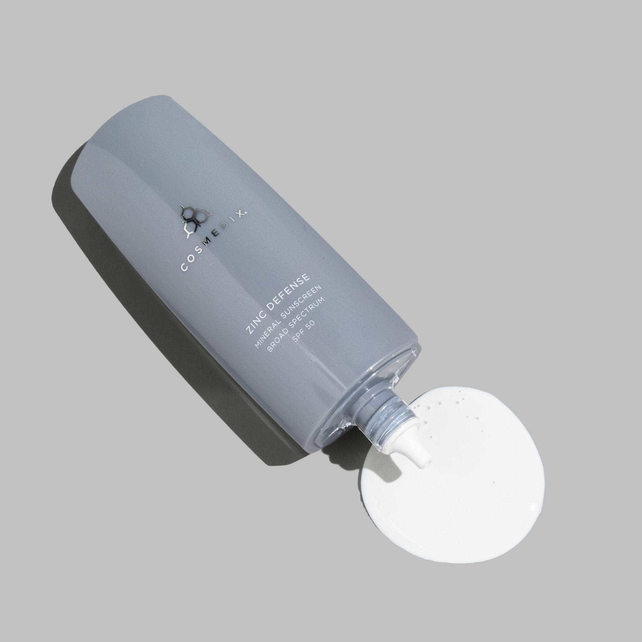 Blue gray Zinc Defense Mineral Sunscreen bottle with white pump dispenser SPF 50
